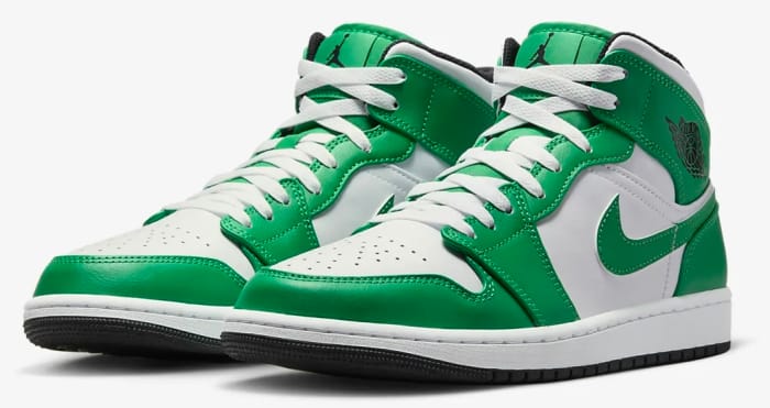 Side view of green and white Air Jordan sneakers.